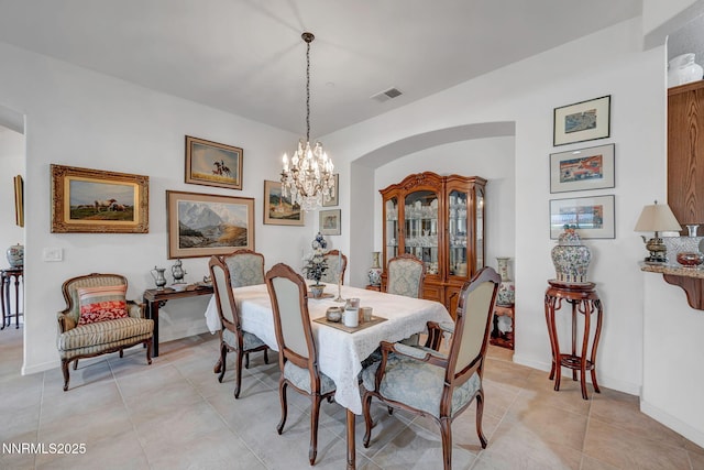 9900 Wilbur May Pkwy Unit 2001, Reno, NV 89521 - dining room featuring light tile patterned floors, a chandelier, and arched walkways
