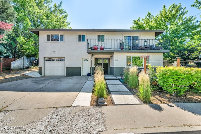 700 Highland St, Carson City, NV 89703 - view of front facade featuring a balcony, stucco siding, a garage, and driveway