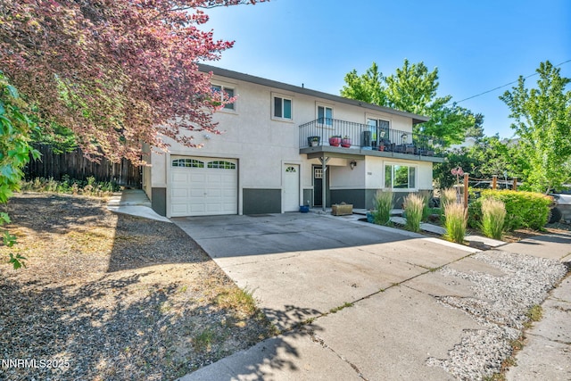 700 Highland St, Carson City, NV 89703 - view of front of house featuring a balcony, a garage, stucco siding, and driveway