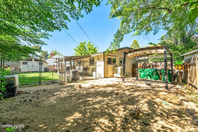 700 Highland St, Carson City, NV 89703 - back of property with a fenced backyard, stucco siding, and a patio area