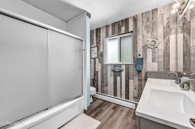 700 Highland St, Carson City, NV 89703 - full bath featuring a baseboard heating unit, wooden walls, double vanity, and wood finished floors