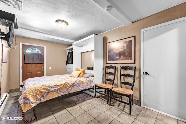 700 Highland St, Carson City, NV 89703 - bedroom with light tile patterned floors and baseboard heating