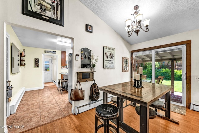 700 Highland St, Carson City, NV 89703 - dining room with a textured ceiling, a chandelier, light wood-type flooring, and high vaulted ceiling