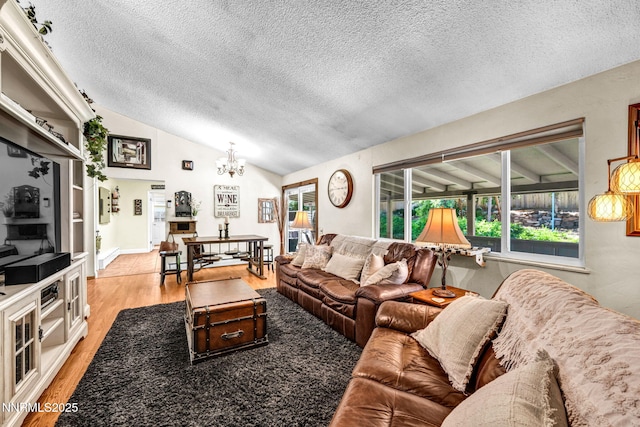 700 Highland St, Carson City, NV 89703 - living area featuring a chandelier, vaulted ceiling, a textured ceiling, and light wood-style flooring