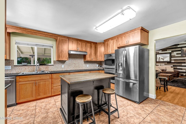 700 Highland St, Carson City, NV 89703 - kitchen with stainless steel appliances, tasteful backsplash, dark countertops, a center island, and a kitchen bar