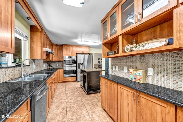 700 Highland St, Carson City, NV 89703 - kitchen with appliances with stainless steel finishes, backsplash, open shelves, brown cabinetry, and dark stone countertops