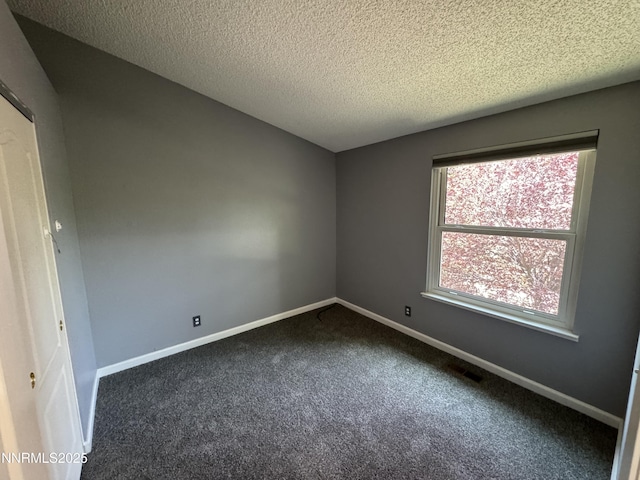 6559 Fall River Cir, Reno, NV 89523 - spare room with dark colored carpet and a textured ceiling