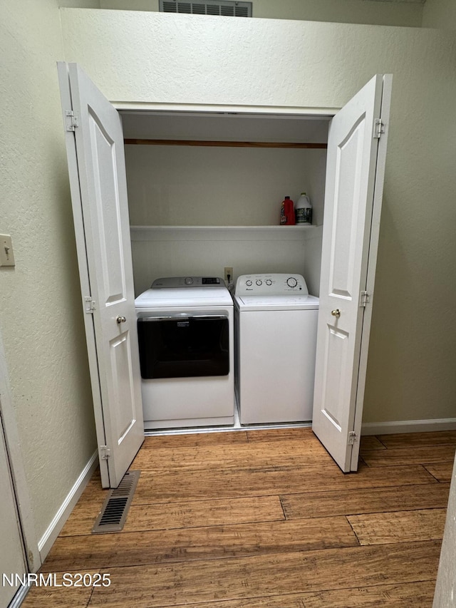6559 Fall River Cir, Reno, NV 89523 - washroom featuring independent washer and dryer, wood finished floors, and a textured wall