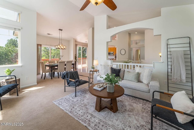 7436 Baysheen Ct, Sparks, NV 89436 - carpeted living room featuring a ceiling fan, vaulted ceiling, and arched walkways