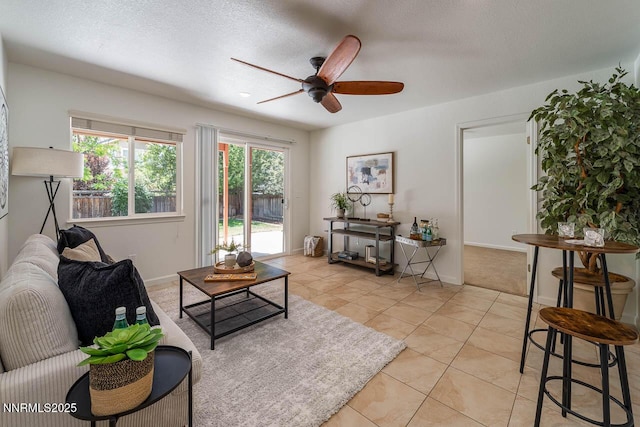 7436 Baysheen Ct, Sparks, NV 89436 - living area featuring a ceiling fan, healthy amount of natural light, light tile patterned floors, and a textured ceiling