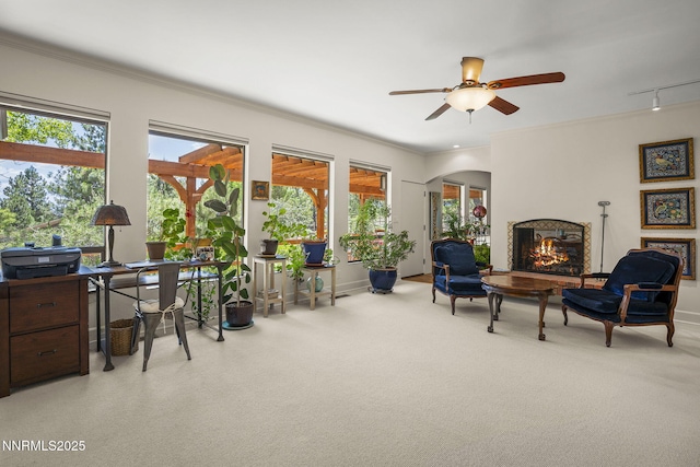 2548 Jacks Valley Rd, Genoa, NV 89411 - living area with carpet floors, a lit fireplace, ornamental molding, arched walkways, and a ceiling fan