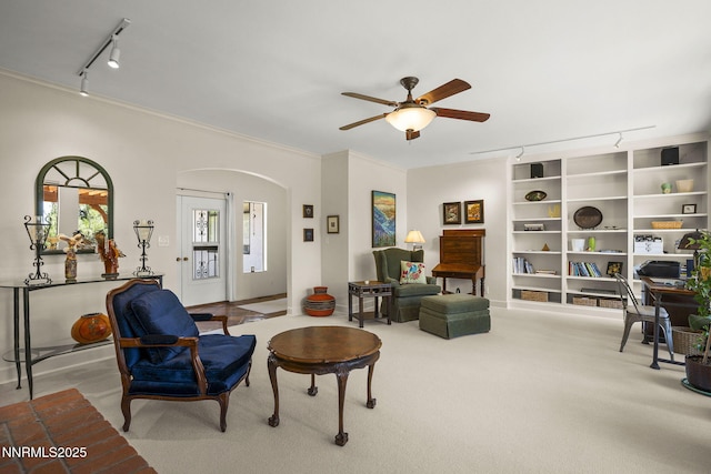 2548 Jacks Valley Rd, Genoa, NV 89411 - living room featuring rail lighting, ceiling fan, arched walkways, crown molding, and carpet floors