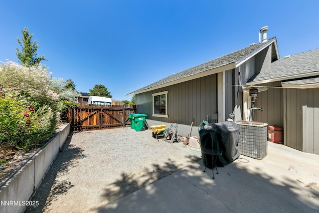 545 Mogul Mountain Dr, Reno, NV 89523 - rear view of house featuring a gate, a shingled roof, and a patio