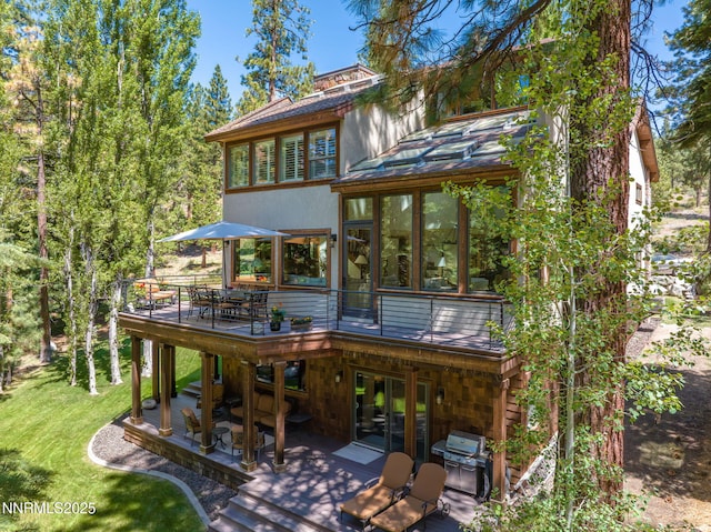 5 Kelly Cir, Glenbrook, NV 89413 - back of house featuring a wooden deck, outdoor dining space, a lawn, a patio area, and a sunroom