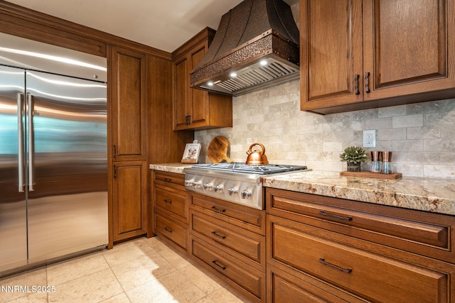 5 Kelly Cir, Glenbrook, NV 89413 - kitchen featuring stainless steel appliances, custom exhaust hood, tasteful backsplash, and brown cabinets