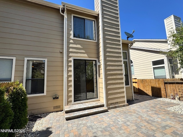 4066 Snowshoe Ln, Reno, NV 89502 - rear view of house featuring a chimney, a patio, entry steps, and crawl space
