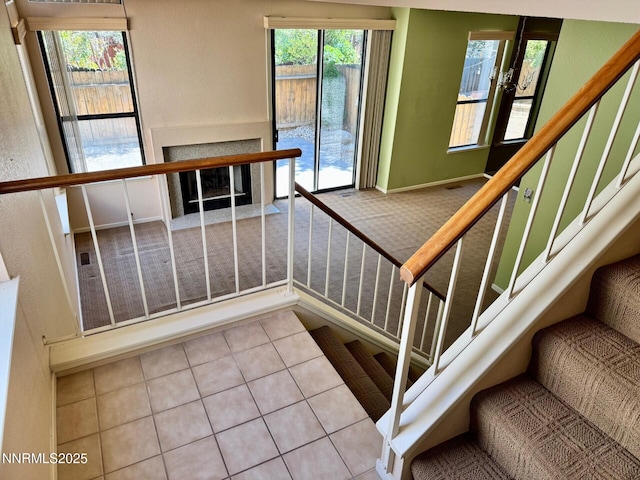 4066 Snowshoe Ln, Reno, NV 89502 - stairway featuring carpet floors, tile patterned floors, and a fireplace with flush hearth