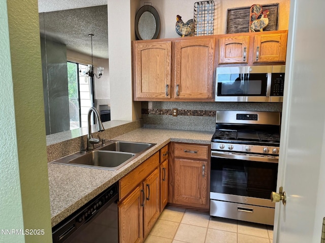 4066 Snowshoe Ln, Reno, NV 89502 - kitchen with appliances with stainless steel finishes, light tile patterned flooring, a textured ceiling, brown cabinetry, and decorative light fixtures