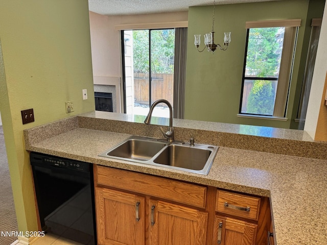 4066 Snowshoe Ln, Reno, NV 89502 - kitchen with black dishwasher, plenty of natural light, a chandelier, and a fireplace