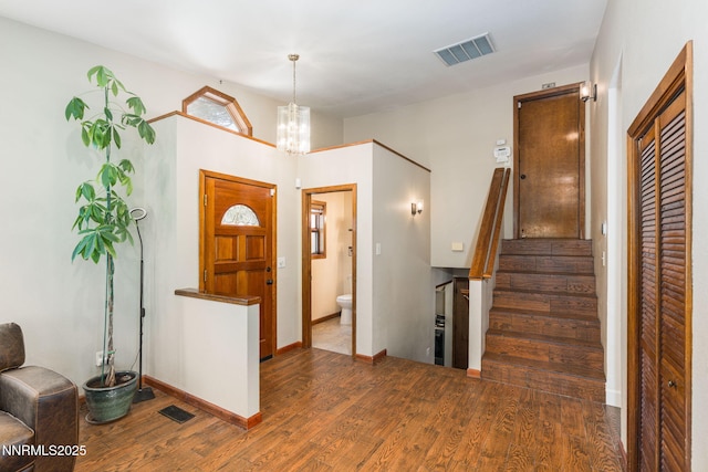 3597 Skyline View Dr, Reno, NV 89509 - entrance foyer with wood finished floors, stairway, and a chandelier