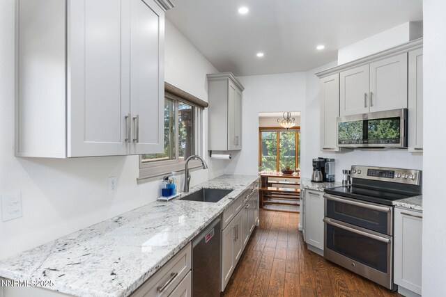 3597 Skyline View Dr, Reno, NV 89509 - kitchen featuring appliances with stainless steel finishes, recessed lighting, light stone counters, gray cabinets, and dark wood-type flooring