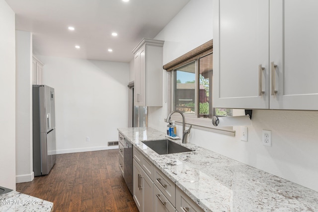 3597 Skyline View Dr, Reno, NV 89509 - kitchen featuring stainless steel appliances, dark wood-style flooring, recessed lighting, and light stone counters