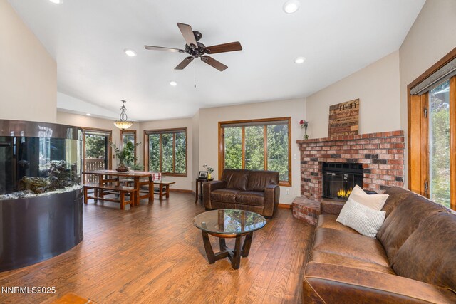3597 Skyline View Dr, Reno, NV 89509 - living room with a brick fireplace, wood finished floors, healthy amount of natural light, recessed lighting, and vaulted ceiling