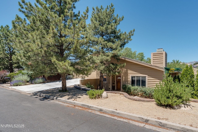 3597 Skyline View Dr, Reno, NV 89509 - obstructed view of property with a chimney and driveway