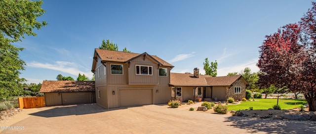 15045 Heathcliff Dr, Reno, NV 89511 - view of front of house featuring a chimney, a garage, decorative driveway, and stone siding