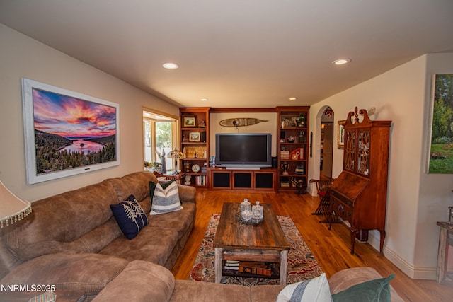 15045 Heathcliff Dr, Reno, NV 89511 - living area with wood finished floors, arched walkways, and recessed lighting