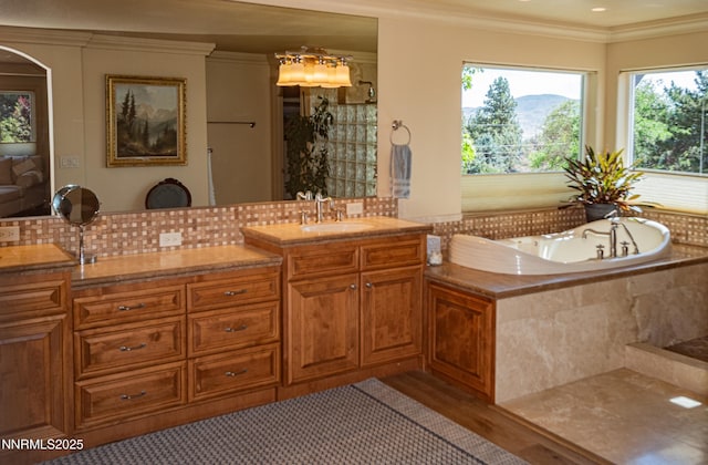 15045 Heathcliff Dr, Reno, NV 89511 - bathroom with ornamental molding, vanity, a bath, backsplash, and wood finished floors