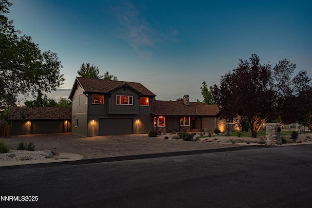 15045 Heathcliff Dr, Reno, NV 89511 - view of front facade with decorative driveway, a chimney, and an attached garage