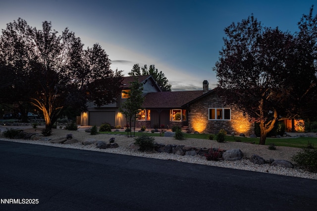 15045 Heathcliff Dr, Reno, NV 89511 - view of front of property featuring stone siding, a chimney, and a garage