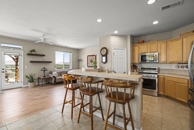 3226 Banestone Rd, Sparks, NV 89436 - kitchen featuring stainless steel appliances, recessed lighting, a breakfast bar, an island with sink, and open floor plan