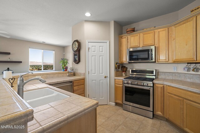 3226 Banestone Rd, Sparks, NV 89436 - kitchen with stainless steel appliances, recessed lighting, tile counters, and open shelves