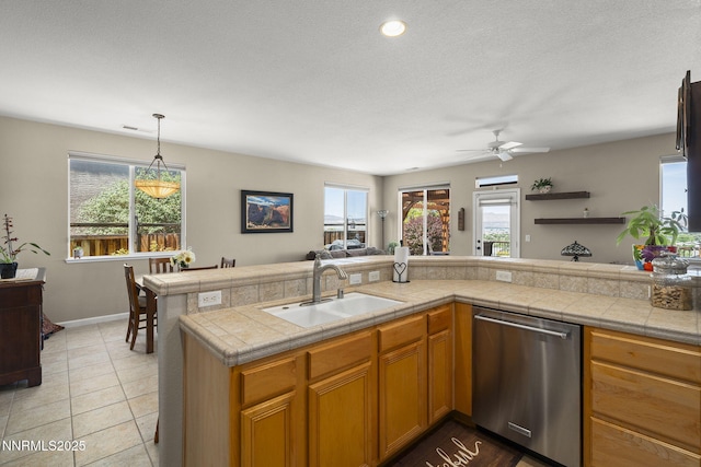 3226 Banestone Rd, Sparks, NV 89436 - kitchen featuring stainless steel dishwasher, open floor plan, ceiling fan, decorative light fixtures, and brown cabinetry