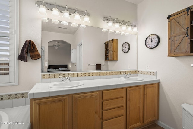 3226 Banestone Rd, Sparks, NV 89436 - ensuite bathroom featuring double vanity, ceiling fan, and a bath