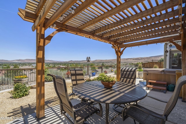 3226 Banestone Rd, Sparks, NV 89436 - view of patio featuring a hot tub, a mountain view, a pergola, and outdoor dining area