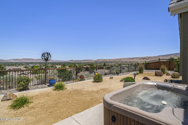 3226 Banestone Rd, Sparks, NV 89436 - fenced backyard with a hot tub and a mountain view