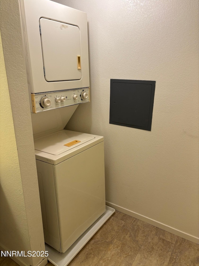 1465 E Peckham Ln Unit 53, Reno, NV 89502 - washroom featuring stacked washer and clothes dryer and baseboards