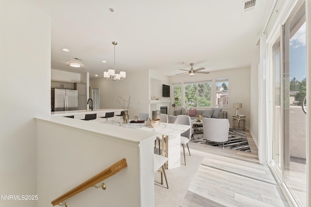 6120 Ingleston Dr Unit 621, Sparks, NV 89436 - kitchen featuring freestanding refrigerator, a chandelier, light countertops, light wood finished floors, and decorative light fixtures