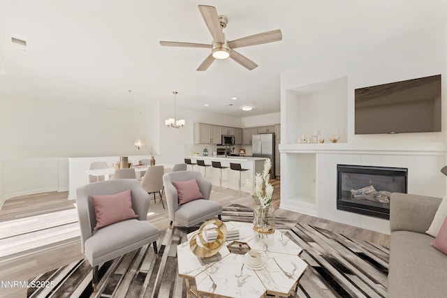 6120 Ingleston Dr Unit 621, Sparks, NV 89436 - living area with a chandelier, ceiling fan, light wood-style floors, a fireplace, and recessed lighting