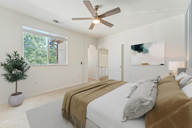 6120 Ingleston Dr Unit 621, Sparks, NV 89436 - bedroom featuring arched walkways, light carpet, and ceiling fan