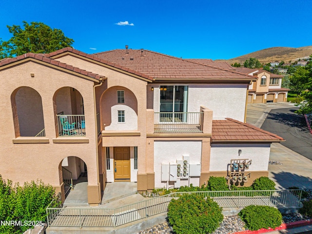 6120 Ingleston Dr Unit 621, Sparks, NV 89436 - view of front facade featuring a balcony, stucco siding, a tiled roof, and a mountain view