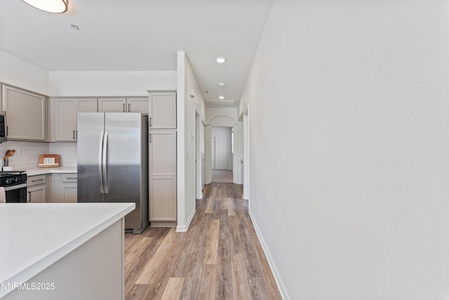 6120 Ingleston Dr Unit 621, Sparks, NV 89436 - kitchen with appliances with stainless steel finishes, gray cabinets, light wood-type flooring, tasteful backsplash, and recessed lighting