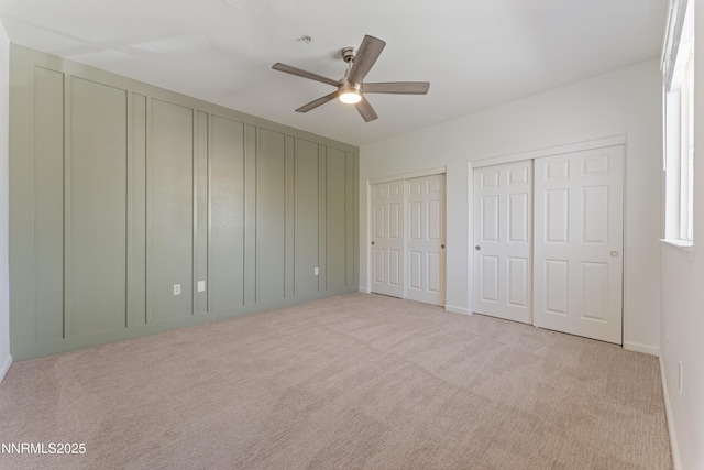 6120 Ingleston Dr Unit 621, Sparks, NV 89436 - unfurnished bedroom featuring multiple closets, light colored carpet, and a ceiling fan