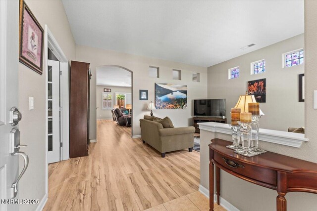 6648 Equation Dr, Sparks, NV 89436 - living area with arched walkways and light wood-style flooring