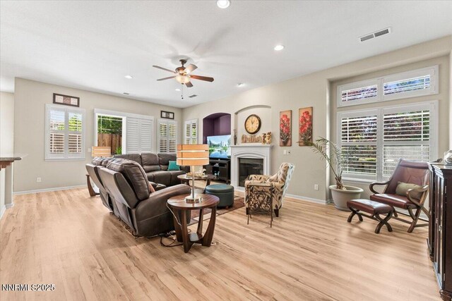 6648 Equation Dr, Sparks, NV 89436 - living area featuring light wood finished floors, a glass covered fireplace, ceiling fan, and recessed lighting