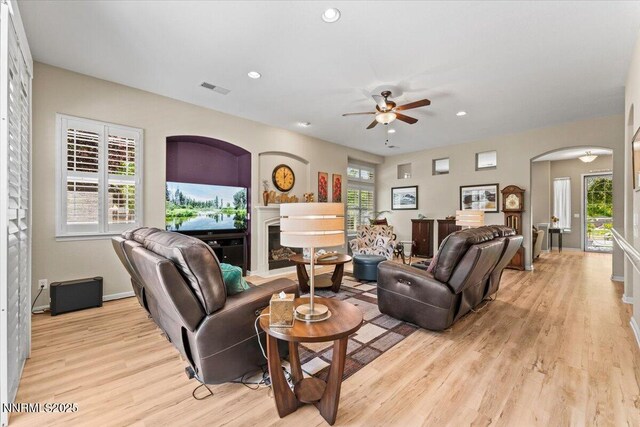 6648 Equation Dr, Sparks, NV 89436 - living room featuring arched walkways, ceiling fan, light wood-style floors, recessed lighting, and a glass covered fireplace