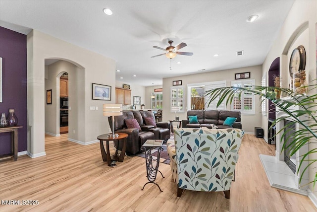 6648 Equation Dr, Sparks, NV 89436 - living area featuring ceiling fan, light wood-style floors, arched walkways, and recessed lighting